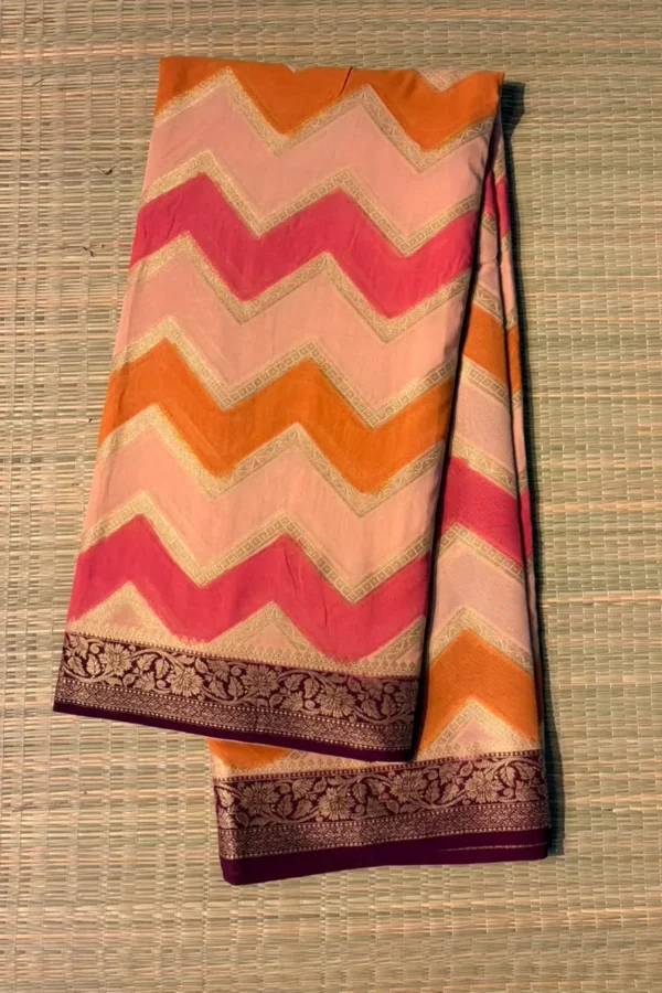 Tricolour (orange, peach and pink) zigzag saree with brown border